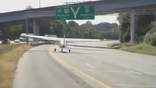 Highwing small airplane taking off from surface of road